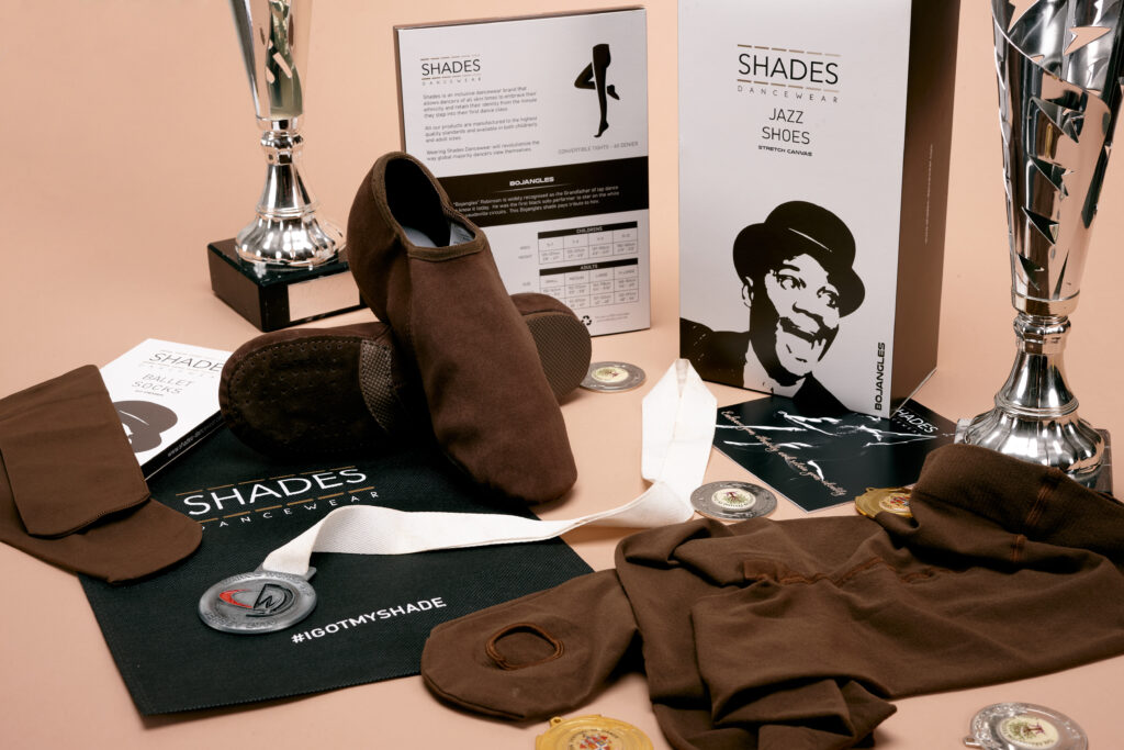 Picture shows the entire Bojangles range, dark brown Jazz shoes, tights and Ballet shoes amongst the packaging and some dance awards